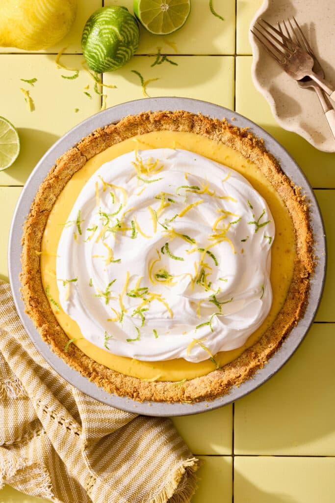 Atlantic beach pie topped with whipped cream and citrus zest in a pie plate.