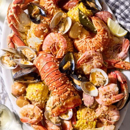 Seafood boil with corn on the cob, red potatoes, lobster, shrimp, and crab.