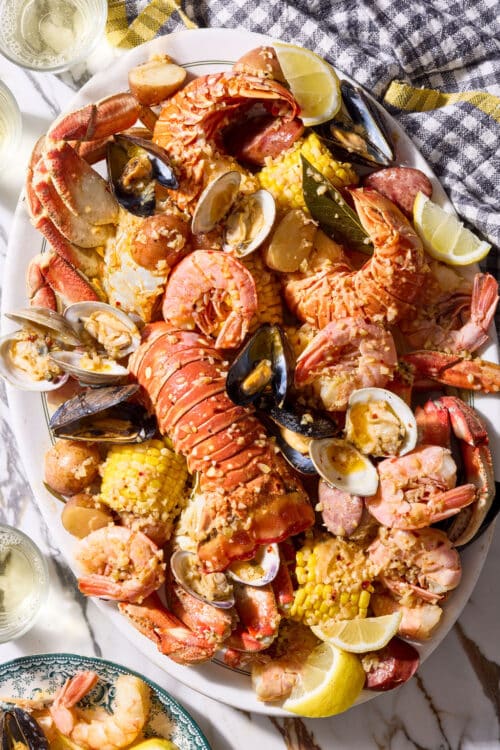 Seafood boil with corn on the cob, red potatoes, lobster, shrimp, and crab.