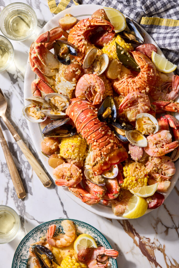 Seafood boil with corn on the cob, red potatoes, lobster, shrimp, and crab.